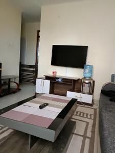 a living room with a tv and a coffee table at Tashie homes in Machakos