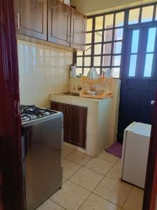 a small kitchen with a stove and a sink at Tashie homes in Machakos