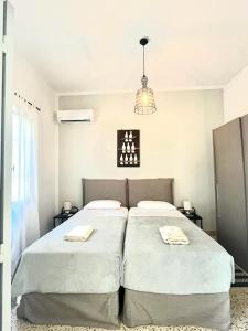 A bed or beds in a room at Aramis Boutique House