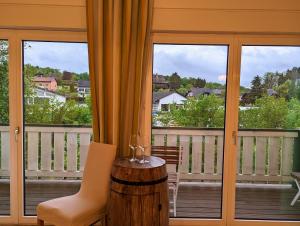 a balcony with a table and chairs and windows at Weinloft Ehrenhausen in Ehrenhausen