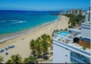 a view of a beach and the ocean at STARFISH LUXURY APARTMENT in San Juan