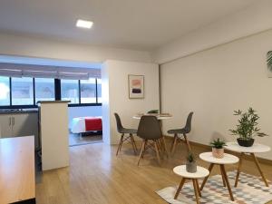 a living room with tables and chairs and a bed at Runawasi Loft - Raywa 1 BDR, Centric and confortable. in Lima