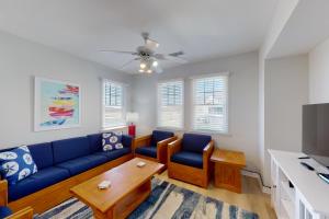 a living room with a blue couch and a table at Tuna #21A-CAC in Buxton