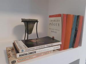four books stacked on top of each other on a shelf at Iria Gardens in Padrón