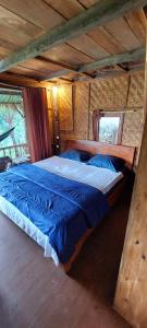 a bedroom with a large bed in a cabin at Second Home Bungalows in Tetebatu
