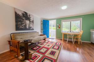 a living room with a couch and a table at The Cabins at Alert Bay in Alert Bay +35 photos