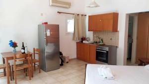 a kitchen with a stainless steel refrigerator and a table at NIKOS & SPIROS in Trapezaki +15 photos