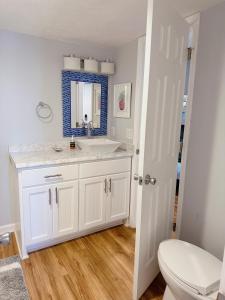 a bathroom with a white sink and a toilet at Ocean View & Easy Beach Access! in Surf City