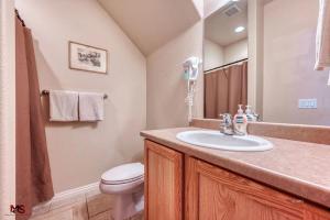 a bathroom with a sink and a toilet at 3BR / 2BA Townhome with Pool, Patio, WiFi, Washer/Dryer in Kanab