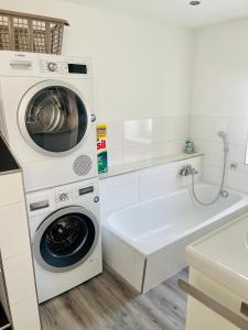 a white laundry room with a washer and dryer at Apartment Lindenstein in Fritzlar