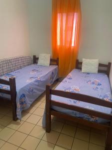 two beds sitting next to each other in a room at Shangrila 2 in Maceió