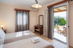 Postel nebo postele na pokoji v ubytování Villa Aphrodite + 11 fotografií