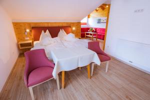 a bedroom with a bed and a table and chairs at Bergerhof in Ramsau am Dachstein