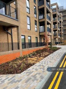 an empty street in front of a brick building at Luxury 2 bed Serviced apartment in Dartford Kent in Kent