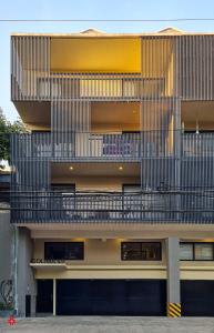 an external view of a building with a balcony at Casa Colima by Kukun in Mexico City