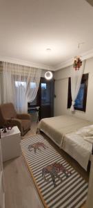 a bedroom with a bed and a living room at Havuzlu Bahçeli Müstakil Villa in Side