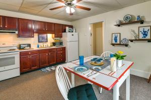 a kitchen with a table with chairs and a white refrigerator at Cozy Mohawk Getaway Near Herkimer Diamond Mines 