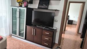a flat screen tv sitting on top of a wooden cabinet at Lovely Apartment inside a quiet Compound in Golem