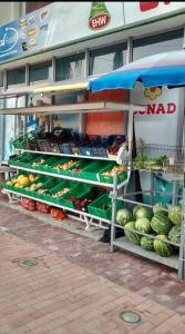 a fruit and vegetable stand in front of a store at Lovely Apartment inside a quiet Compound in Golem