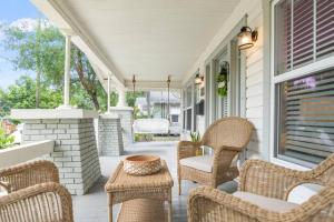 a porch with wicker chairs and a fireplace at BeeKeeper's Inn in Tampa