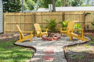 two chairs and a fire pit in a backyard at BeeKeeper's Inn in Tampa