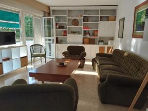 a living room with couches and a coffee table at Conde de Vallellano in Córdoba