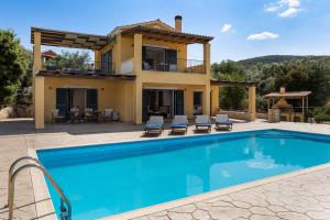 a villa with a swimming pool and a house at Villa Kallisti in Meganisi