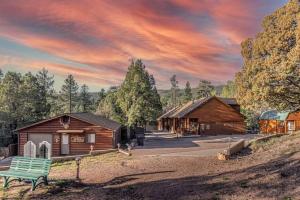 a wooden cabin with a bench in front of it at Cabin#2 Elk Hallow - Pet Friendly - Sleeps 6 - Playground & Game Room in Payson
