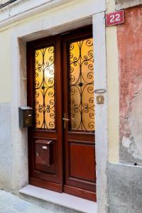 a wooden door in a building with a sign on it at Royal Suite Mia in Piran