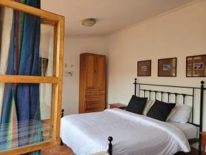 a bedroom with a bed and a mirror at Casa Macondo Bed & Breakfast in Cuenca