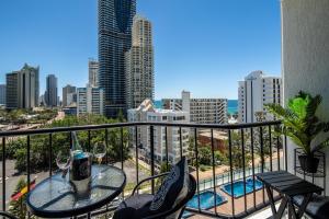 a balcony with a table and chairs and a view of the city at Designer Suites - Versace On View in Gold Coast
