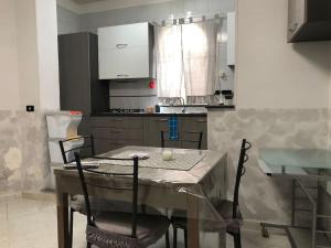 a kitchen with a table with chairs and a table and a kitchen with at House Volla in Volla