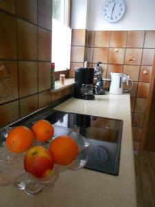 Ein Haufen Orangen in Schalen auf einer Theke in einer Küche in der Unterkunft Tannhäuser Ferienwohnung in Bad Dürrheim