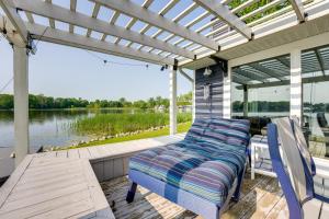 a porch with four chairs and a pergola at Waterfront Retreat, 10 Mi to Dtwn Shipshewana in Middlebury