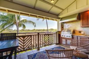 a kitchen with a balcony with a table and chairs at Luxe Maunalani Resort Condo with Pool and Beach Access in Waikoloa