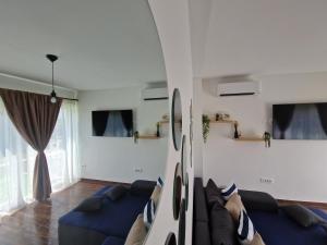 a living room with a couch and a bed at Apartmani Meri in Privlaka