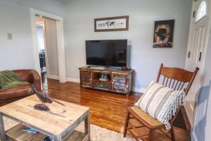 a living room with a television and a coffee table at Bandera Bungalow - River, Downtown, Peaceful fenced corner lot! King bed! in Bandera