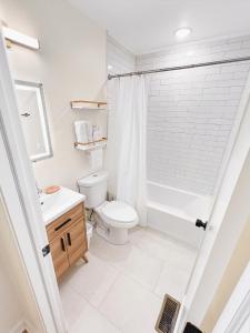 a bathroom with a toilet and a sink and a shower at Rivera Properties in Washington