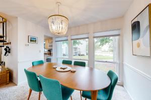 a dining room with a wooden table and green chairs at Sea Colony --- 3201 Round Robin in Bethany Beach