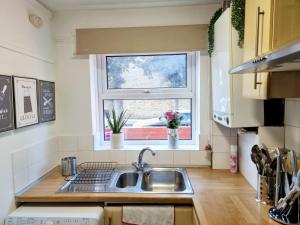 a kitchen with a sink and a window at Underwood at Shoreditch in London