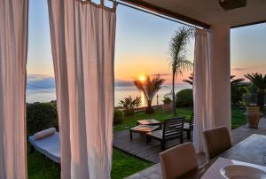 a patio with a view of the ocean from a house at Villa Zagara Garden Spectacular Sea View in Taormina in Taormina