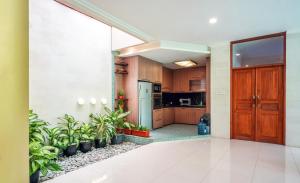 a kitchen with wooden cabinets and potted plants at Villa LOGAN - KUTA - 5 Bedroom - 3 Bathroom Villa - Great Location in Kuta