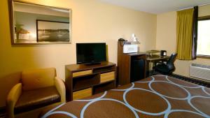 a hotel room with a bed and a television at Super 8 by Wyndham Red Wing in Red Wing