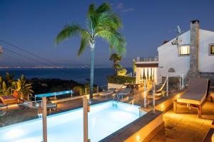a villa with a swimming pool at night at Villa Zagara Garden Spectacular Sea View in Taormina in Taormina