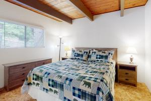 a bedroom with a bed and a window at Rocky Pines in Twin Peaks