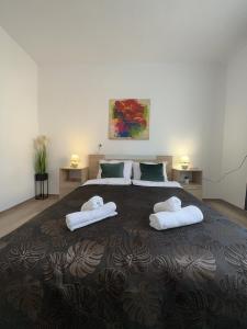a bedroom with a large bed with towels on it at Apartment ADELINA in Tsarevo