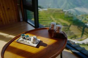 a wooden table with figurines on top of a table with a view at Longji One Art Hotel in Longsheng