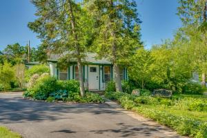 a house with a bench in front of a driveway at Walk to Delavan Lake Extended Stay Home with Yard in Delavan