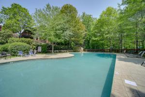 a swimming pool in a yard with chairs and trees at Lake Access and On-Site Creek Lake Toxaway Home! in Lake Toxaway