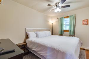 a bedroom with a white bed and a ceiling fan at Henderson Vacation Rental Less Than 1 Mi to Norfork Lake! in Henderson